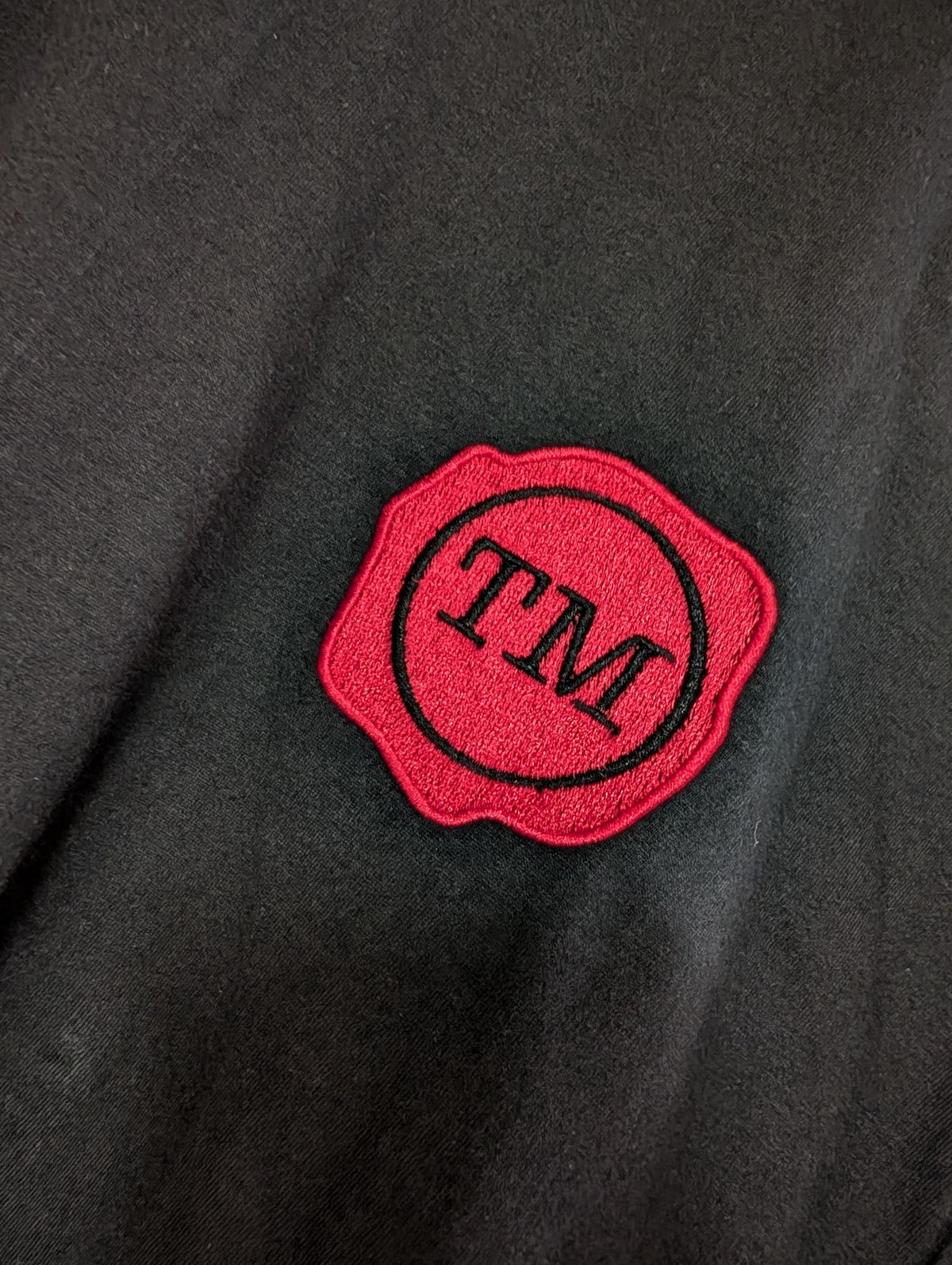 Taskmaster Wax Seal Embroidered Black T-Shirt | Classic Red Wax Seal Chest Embroidery | Unisex Cotton Tee